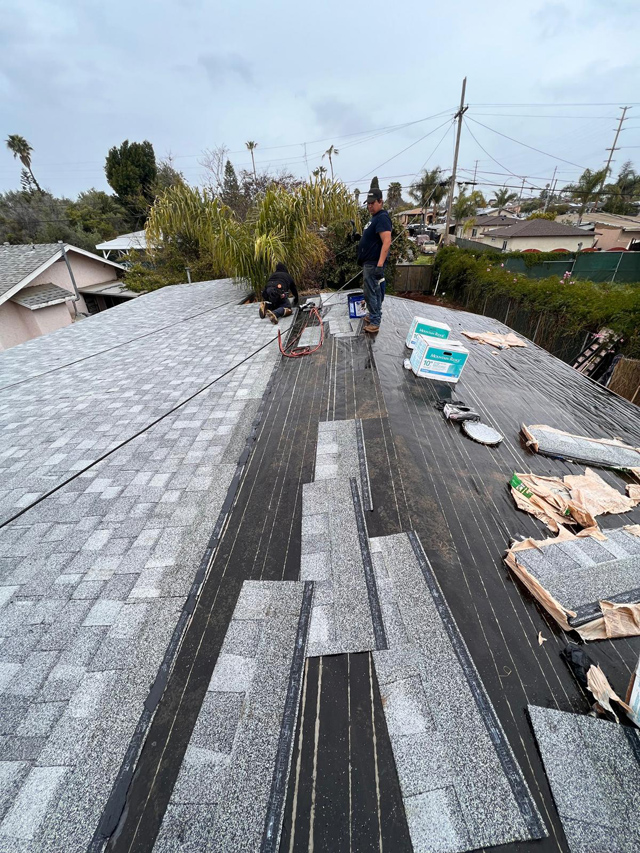 Roof shingle installation on waterproofed surface.