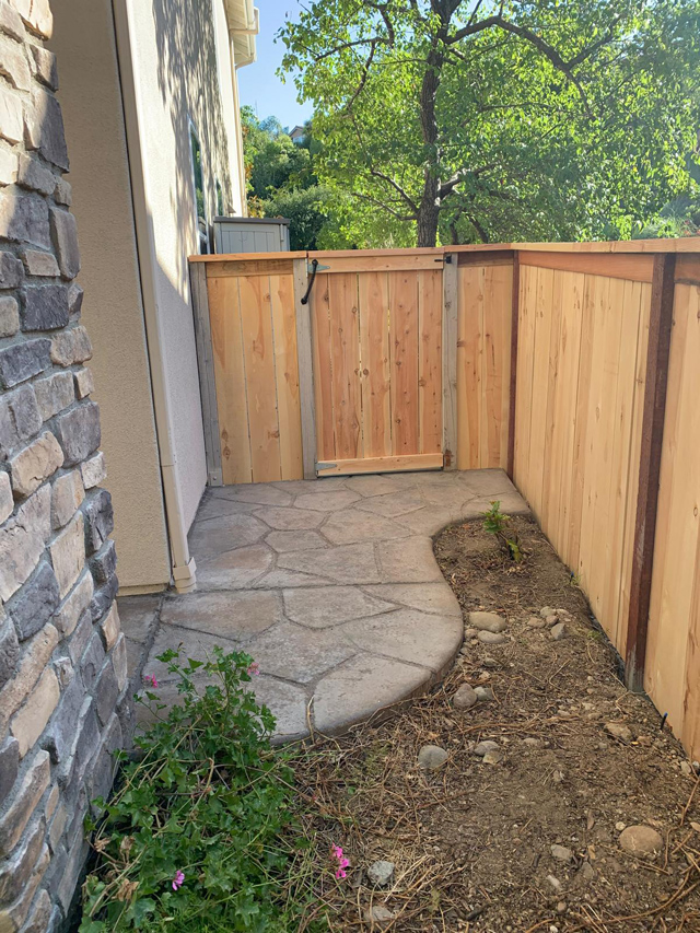 Sturdy wooden yard fence, rustic charm.