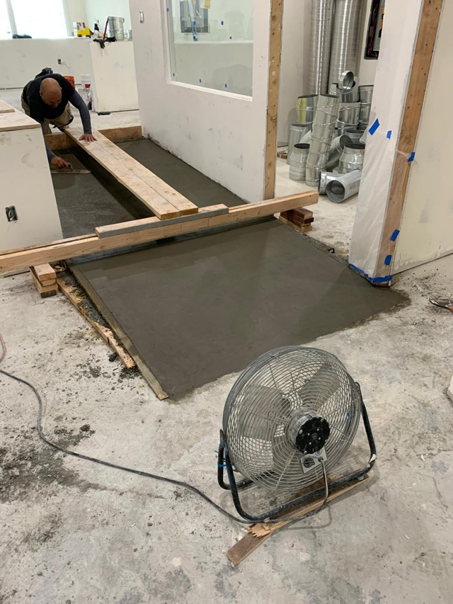 Indoor office cement ramp under construction, smooth and sturdy.