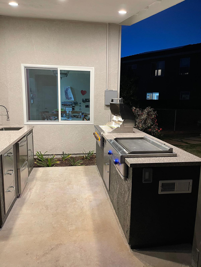 Completed outdoor deck grill and faucet, perfect for outdoor cooking and convenience.