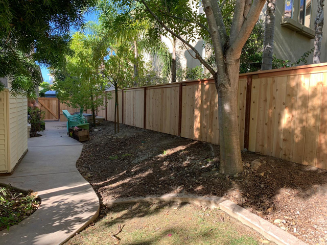 Sturdy wooden fence installed in the yard for privacy and style.