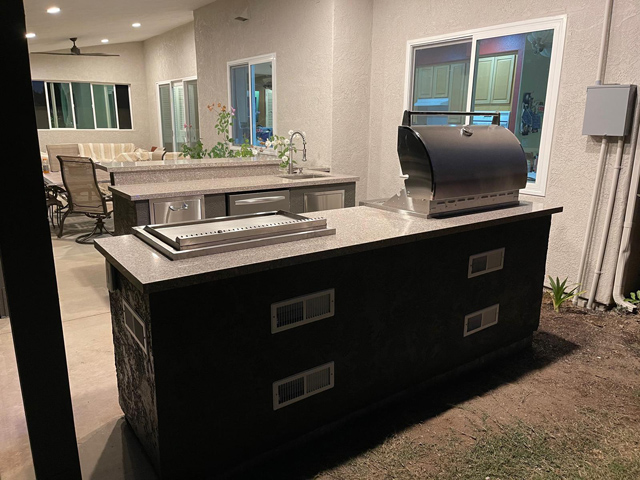 Finished outdoor deck with grill area and cozy seating, perfect for gatherings.