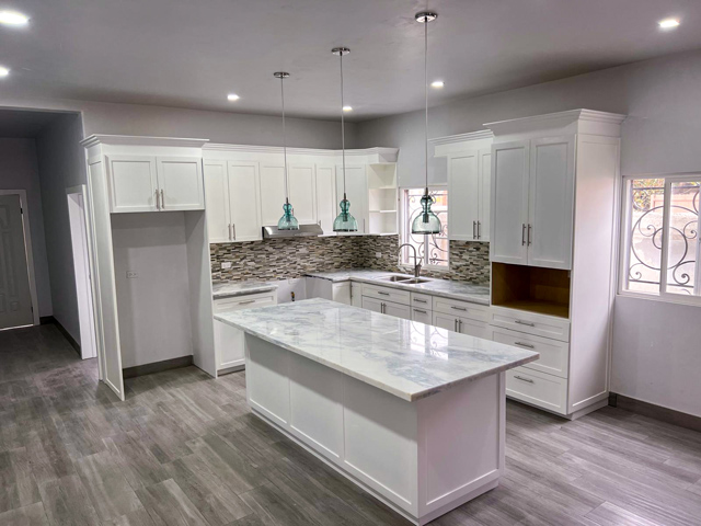 Pearl white finished kitchen with elegant lighting, creating a sleek and modern ambiance.